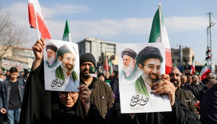 Supporters hold placards bearing images of Mojtaba Khamenei during a gathering in Tehran. — Reuters/File