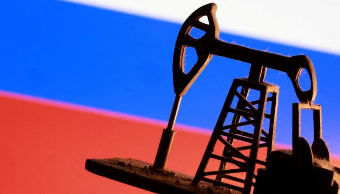 A model of an oil pump is seen in front of a Russian flag in this illustration taken January 9, 2026. — Reuters
