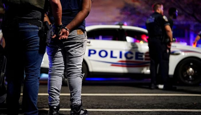 Representative image shows an agent from the US Immigration and Customs Enforcements Homeland Security Investigations (HSI) holding a detained man during a traffic stop, in Washington, DC, US, August 17, 2025. — Reuters