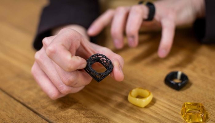Zuzanna Franczak - assistant instructor at the Experimental Design Studio, presents a ring she designed as a student at the Academy of Fine Arts in Gdansk, Poland, on March 11, 2026. — AFP