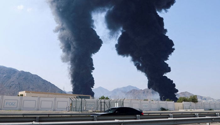 Smoke rises in the Fujairah oil industry zone, caused by debris after interception of a drone by air defenses, according to the Fujairah media office, amid the US-Israel conflict with Iran, in Fujairah, United Arab Emirates, March 14, 2026. — Reuters