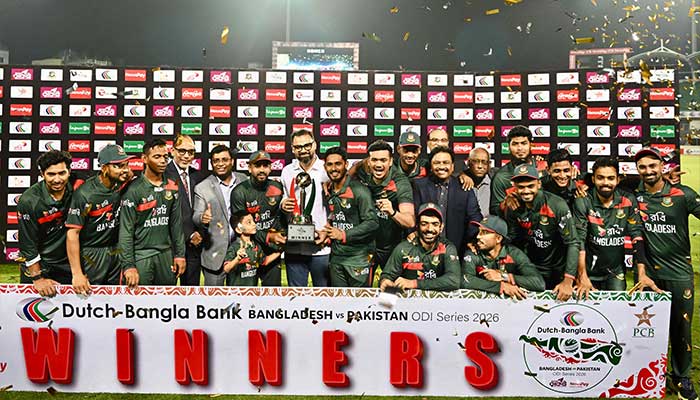 Bangladesh cricketers and support staff pose with the tournament trophy after the third One-Day International (ODI) cricket match between Bangladesh and Pakistan at the Sher-e-Bangla National Stadium in Mirpur on March 15, 2026. - AFP
