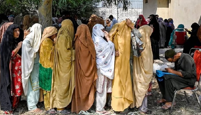 Women align in queues to receive financial aid under the Benazir Income Support Programme, in Peshawar on September 19, 2024.— AFP