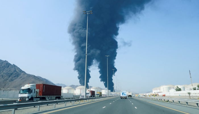 Smoke rises in the Fujairah oil industry zone, caused by debris after interception of a drone by air defenses, according to the Fujairah media office, amid the US-Israel conflict with Iran, in Fujairah, United Arab Emirates, March 14, 2026. — Reuters