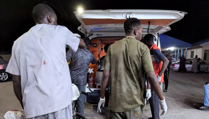 Members of the Nigerian Red Cross assist wounded victims into an ambulance after multiple explosions struck the northeastern city of Maiduguri, Borno State, Nigeria, March 16, 2026. — Reuters