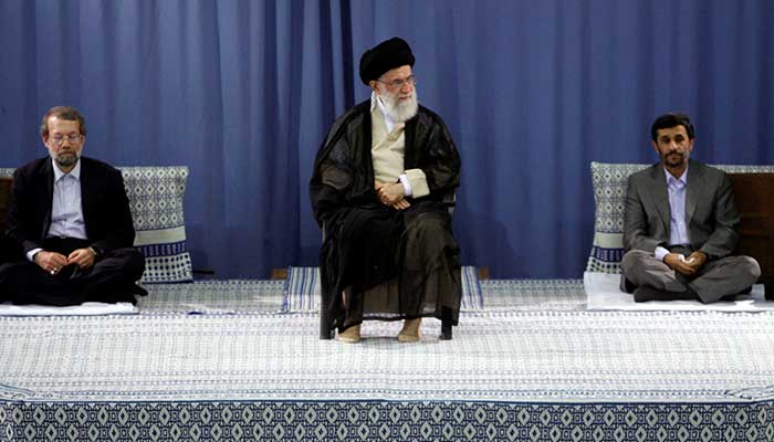 Former Iranian president Mahmoud Ahmadinejad (R) and ex-parliament speaker Ali Larijani (L) listen to a speech by late Supreme Leader Ayatollah Ali Khamenei during a ceremony for Ahmadinejads confirmation as Irans president in Tehran August 3, 2009. — Reuters