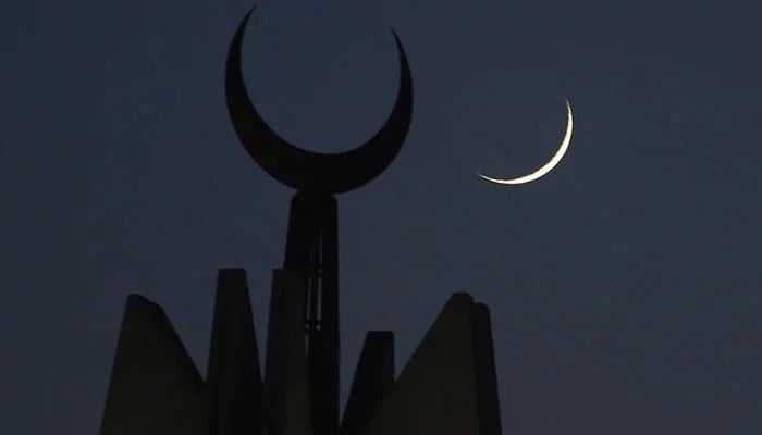 A representational image showing the moon rising over the giant Faisal Mosque in Islamabad. — AFP/File