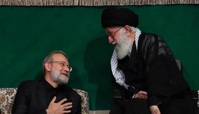 Iranian security chief Ali Larijani (L) talks to supreme leader Ayatollah Ali Khamenei (R), in this undated picture. — www.iranintl.com