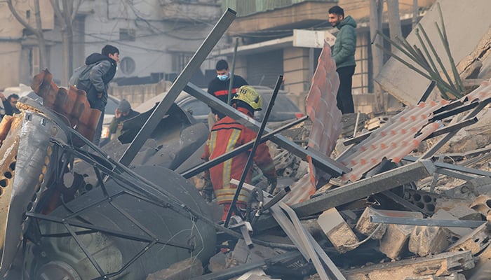 Emergency personnel and people look at the site of a collapsed building, in the aftermath of an Israeli strike in central Beiruts Bachoura neighbourhood, Lebanon, March 18, 2026. — Reuters
