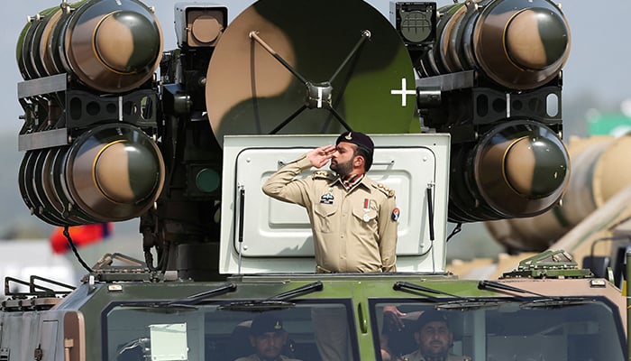 Pakistani Army soldier salutes while standing on an air defence missile system during Pakistan Day military parade in Islamabad, Pakistan, March 23, 2022. — Reuters