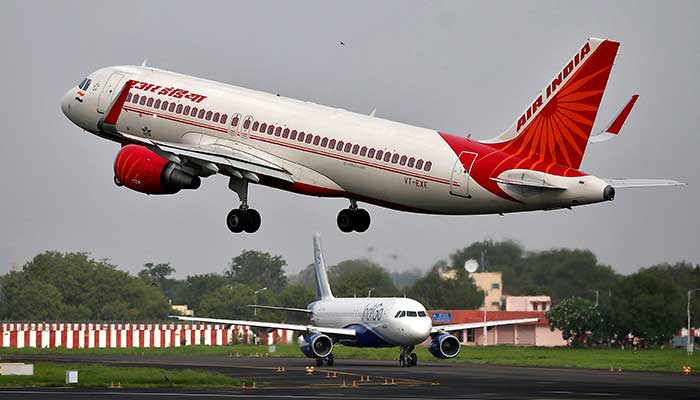 An Air India Airbus A320-200 aircraft takes off as an IndiGo Airlines aircraft waits for clearance at the Sardar Vallabhbhai Patel International Airport in Ahmedabad, India, July 7, 2017. — Reuters