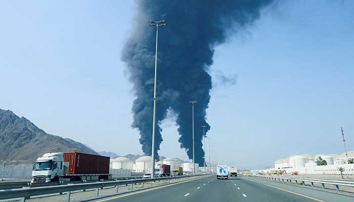 Smoke rises in the Fujairah oil industry zone, caused by debris after interception of a drone by air defenses, according to the Fujairah media office, amid the US-Israel conflict with Iran, in Fujairah, United Arab Emirates, March 14, 2026. — Reuters