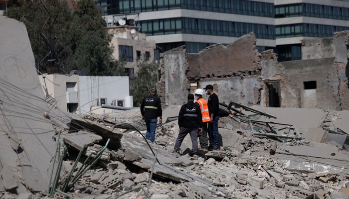 'War has aged us': Lebanon's kids aren't alright 16 People stand amidst debris at the site of an Israeli strike, following an escalation between Hezbollah and Israel amid the US-Israeli conflict with Iran, Zuqaq al-Blat district in central Beirut, Lebanon, March 18, 2026.— Reuters