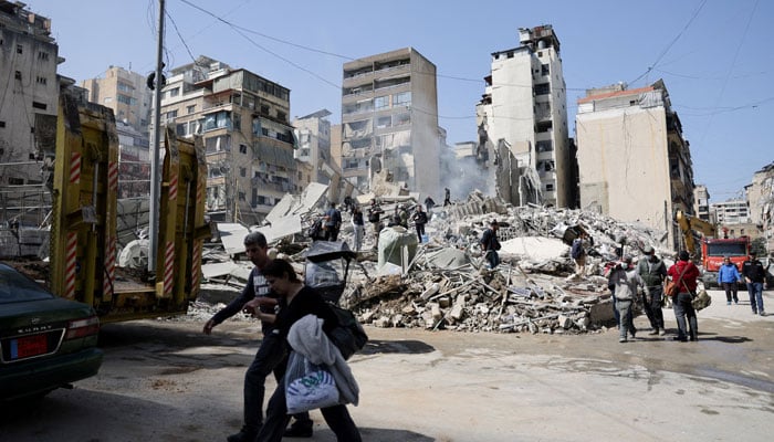 'War has aged us': Lebanon's kids aren't alright 17 People walk near debris at the site of an Israeli strike, following an escalation between Hezbollah and Israel amid the US-Israeli conflict with Iran, Zuqaq al-Blat district of central Beirut, Lebanon, March 18, 2026. — Reuters