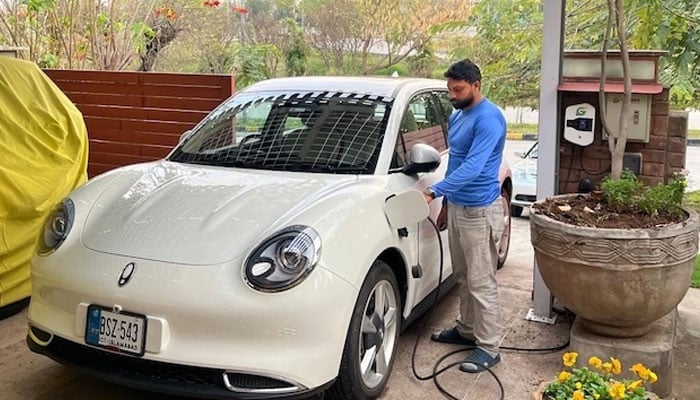 Pakistan's solar boom to tide over Middle East energy crisis 12 Vaqar Zakaria’s white EV charges under rooftop solar panels at his home, powered by the sun. — Vaqar Zakaria