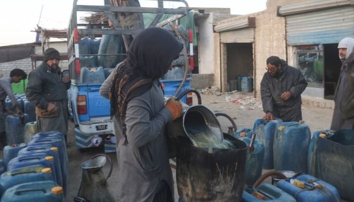 A man fills a canister with petrol, brought from Iran, amid the US-Israel conflict with Iran, at a roadside depot on the outskirts of Quetta, March 4, 2026. — Reuters
