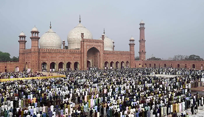 Muslim devotees offer Eid ul Fitr prayers, which marks the end of the Islamic holy fasting month of Ramadan, at the Badshahi Mosque in Lahore on March 21, 2026. — AFP