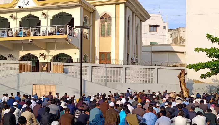 People attend Eid ul Fitr prayers outside a mosque in Karachi on March 21, 2026. — Geo.tv