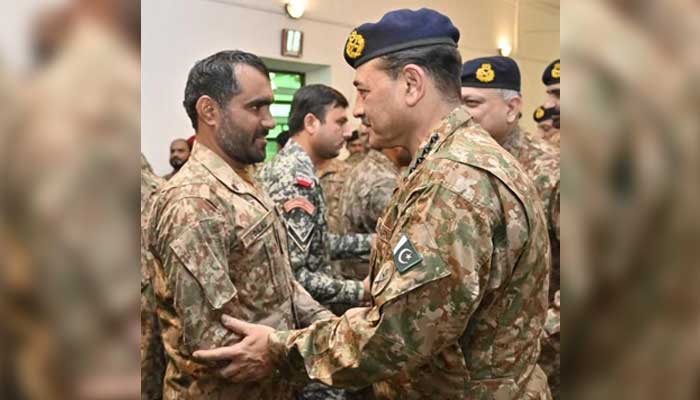 CDF Field Marshal  Asim Munir interacts with a soldier on Eid ul Fitr in Kurram, on March 21, 2026. — ISPR