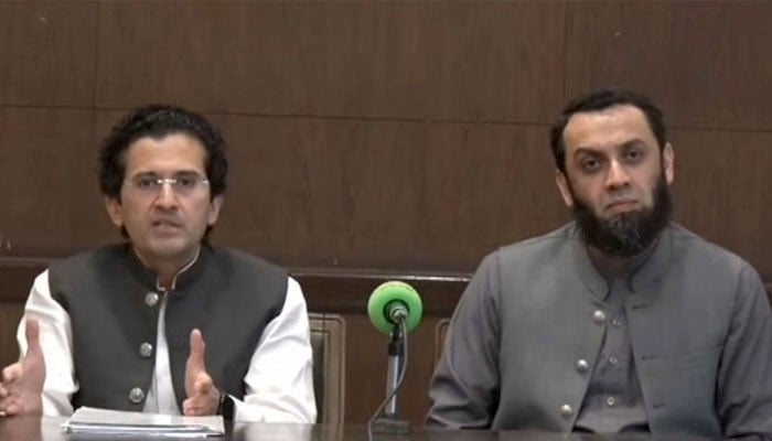 Federal minister Atta Tarar (right) and Ali Pervaiz Malik addressing press conference on March 21, 2026. — Screengrab via GeoNews