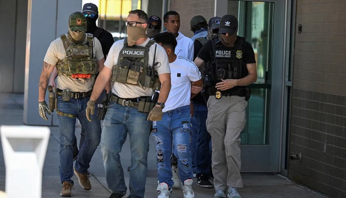 Law enforcement officers, including HSI and ICE agents, take people into custody at an immigration court in Phoenix, Arizona, May 22. — Reuters
