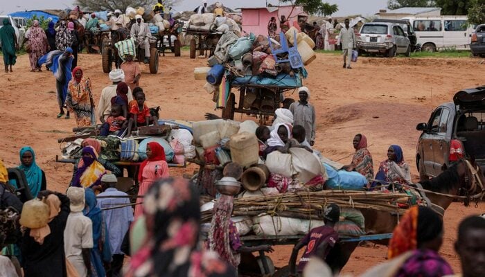 Chadian cart owners transport belongings of Sudanese people who fled the conflict in Sudans Darfur region, while crossing the border between Sudan and Chad in Adre, Chad August 4, 2023. — Reuters