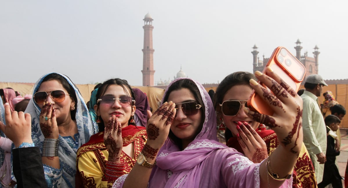 Women react as they take a selfie after attending an Eid ul Fitr prayer to mark the end of the fasting month of Ramadan, at the Badshahi Mosque in Lahore, Pakistan March 21, 2026. — Reuters