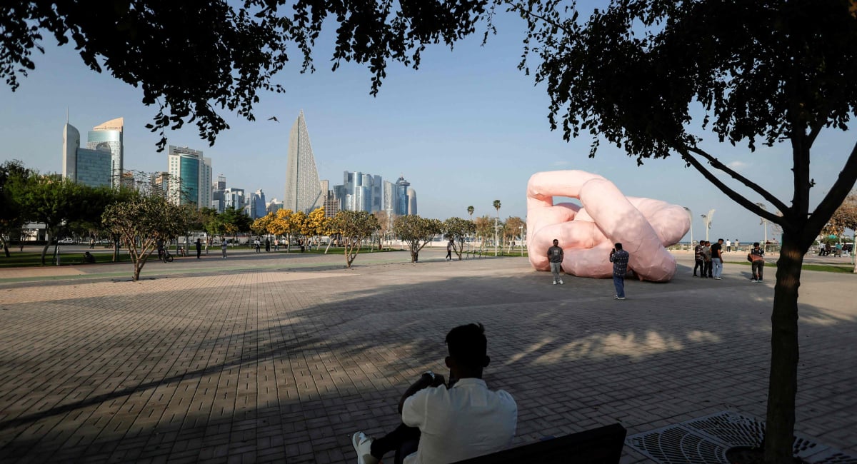 A man sits along the seafront Corniche on the second day of Eid ul Fitr celebrations, marking the end of the Muslim holy month of Ramadan, in Doha on March 21, 2026. — AFP