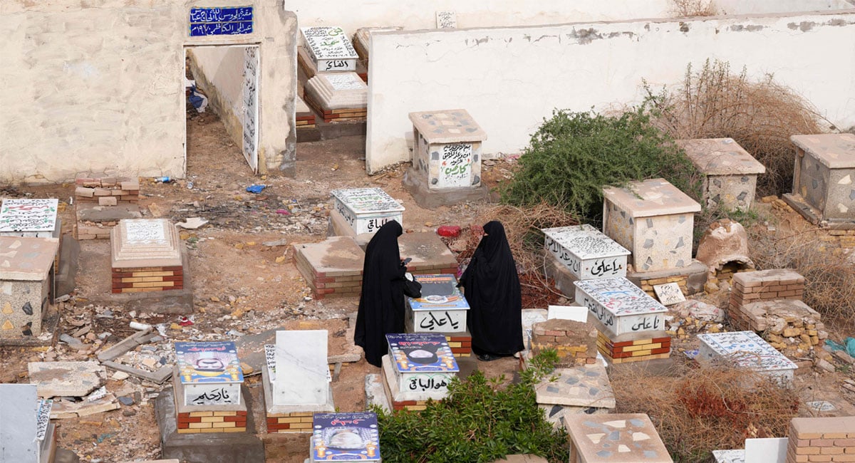 Iraqi women visit a grave at Wadi al-Salam Cemetery in Iraqs central holy city of Najaf to remember the deceased as well as victims of wars as they celebrate Eid ul Fitr, marking the end of the fasting month of Ramadan, on March 21, 2026. — AFP