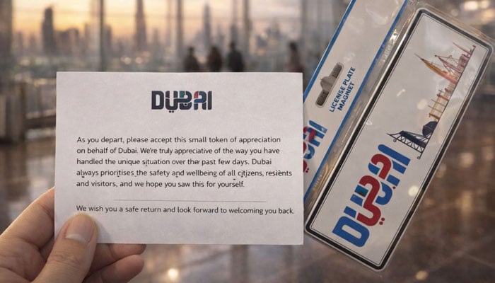 A passenger at Dubai International Airport holds a thank-you card, handed by the authorities, appreciating their patience over the past few days and expressing hope for a safe return. — Geo News