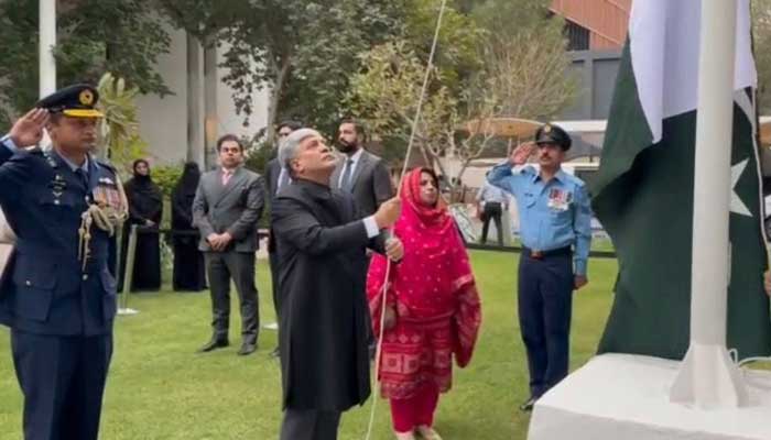 Pakistani Ambassador Shafqat Ali Khan hoisting the Pakistan flag at the embassy on Pakistan Day. — X/@PakinUAE_