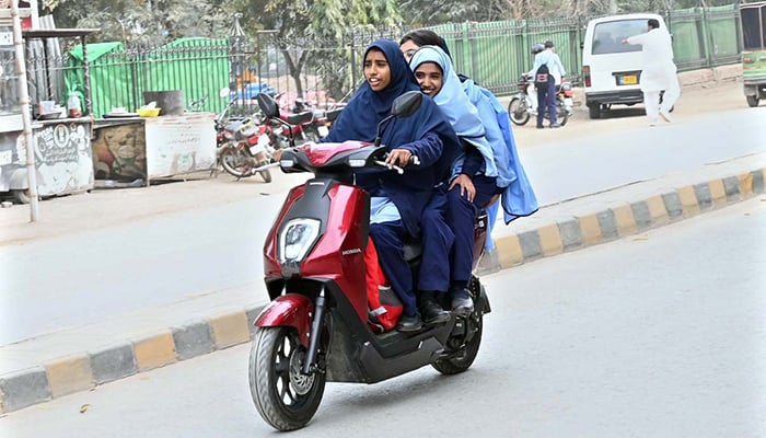 Students on their way to school on a scooty in Sargodha’s Satellite Town, on February 17. 2026. — APP