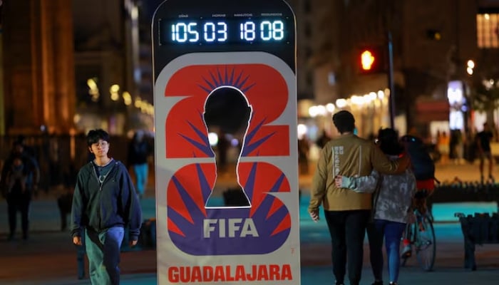 People walk past a countdown clock for the Fifa World Cup 2026 on a street, in Guadalajara, Mexico, February 25, 2026. — Reuters