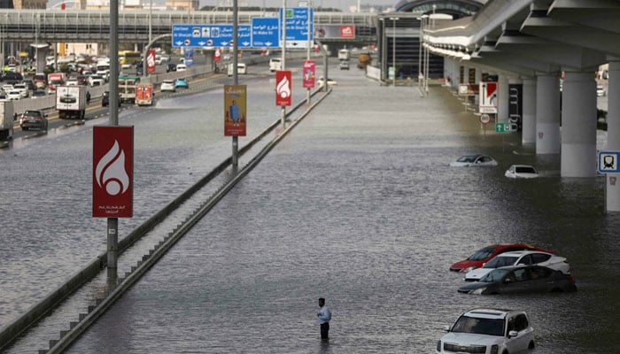 This representational image shows a person stands surrounded by flood water caused by heavy rains, in Dubai, United Arab Emirates on April 17. — Reuters