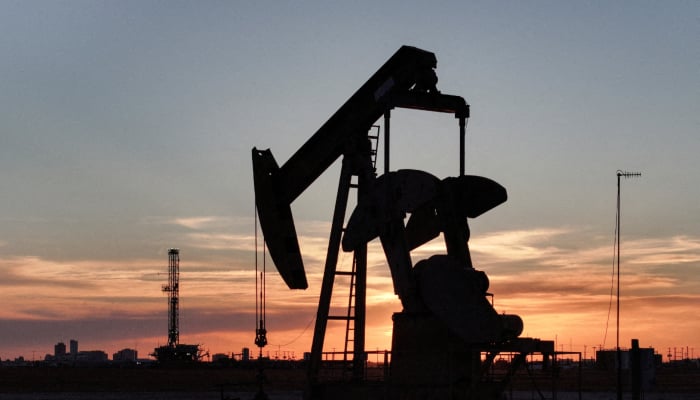 A drone view of a pump jack and drilling rig south of Midland, Texas, US June 11, 2025. — Reuters