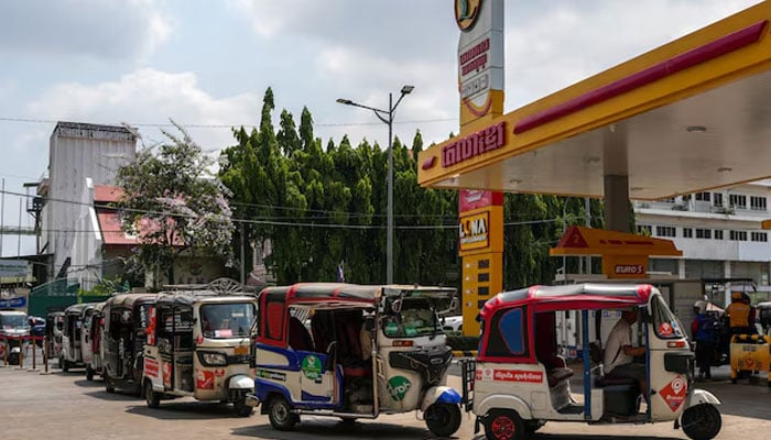Tuk-tuks queue to fill LPG and gasoline at a gas station, amid the U.S.-Israeli conflict with Iran, in Phnom Penh, Cambodia, March 24, 2026. — Reuters