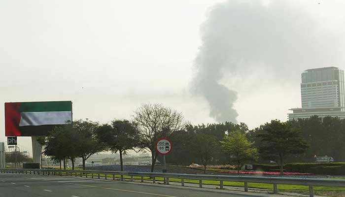 Smoke rising from an area near the Dubai International Airport is seen through the windshield of a vehicle, after a drone attack hit a fuel tank, according to Dubai authorities, amid the US-Israel conflict with Iran, in Dubai, United Arab Emirates, March 16, 2026. — Reuters