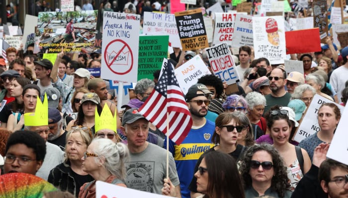 Protestors carrying placards during Protect Migrants, Protect the Planet” rally in New York City, US, April 19, 2025. — Reuters