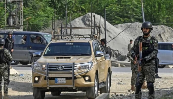 Security personnel stand guard in Bajaur district of Khyber Pakhtunkhwa. — AFP/File