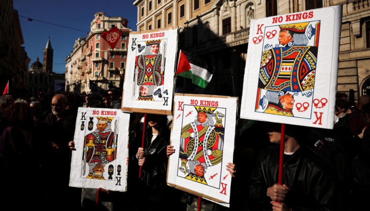 Protesters hold banners with playing card motifs during a nationwide No Kings demonstration, part of a coordinated international mobilisation, amid rising political tensions and following Prime Minister Giorgia Melonis recent defeat in the referendum, in Rome, Italy, March 28, 2026.