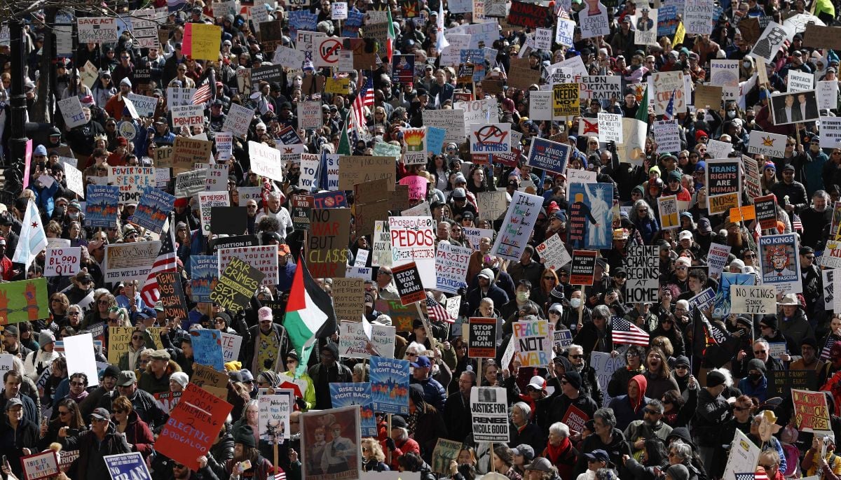 People hold signs and flags as they march during the No Kings national day of protest in Chicago on March 28, 2026. — AFP