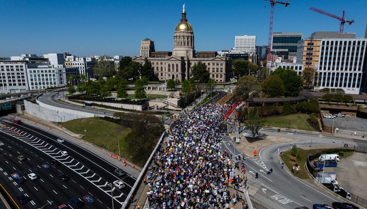 An aerial view shows people marching near the Georgia state Capitol building during the No Kings national day of protest in Atlanta, Georgia, on March 28, 2026. — AFP
