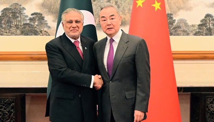 Chinese Foreign Minister Wang Yi (right) greets Deputy Prime Minister and Foreign Minister Ishaq Dar in Beijing on May 20, 2025. — X@ForeignOfficePk