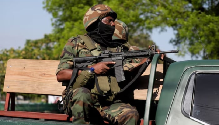 Law enforcement officers patrol amid ongoing gang violence, in this file photo from Haiti, March 19, 2025. REUTERS/Ralph Tedy Erol/File Photo Purchase Licensing Rights