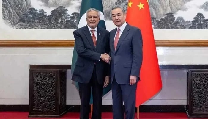 Chinese Foreign Minister Wang Yi (right) greets Deputy Prime Minister and Foreign Minister Ishaq Dar in Beijing on May 20, 2025. — Xinhua