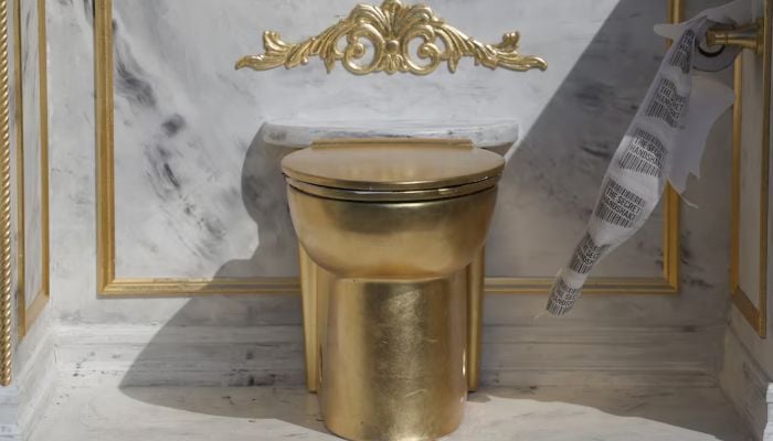 Toilet paper with the message the secret handshake written on it moves with the wind as it is displayed as part of a statue featuring a large golden toilet, titled A Throne Fit for a King, near the Lincoln Memorial on the National Mall in Washington, DC, US, March 30, 2026. — Reuters