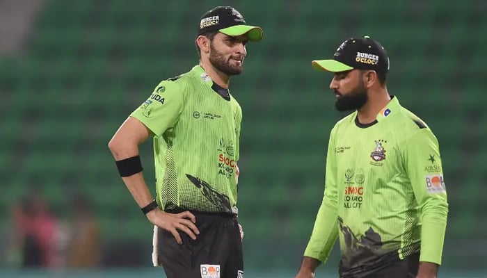 Lahore Qalandars’ captain Shaheen Shah Afridi (left) speaks with teammate Fakhar Zaman during the Pakistan Super League match between Karachi Kings and Lahore Qalandars at the Gaddafi Cricket Stadium in Lahore, March 29, 2026. — AFP