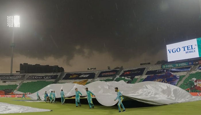 Ground staff carry covers onto the pitch at Gaddafi Stadium, Lahore, as heavy rain approaches, March 31, 2026. — PSL