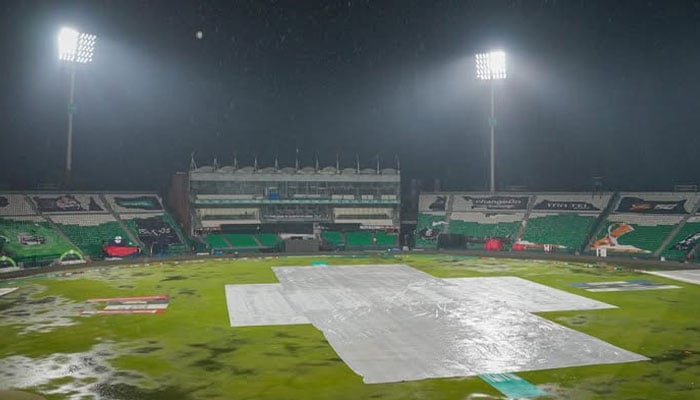 A rain-soaked Gaddafi Stadium with covers laid over the pitch as Pakistan Super League 11 match between Islamabad United and Peshawar Zalmi was called off following rain on March 31, 2026. — PSL
