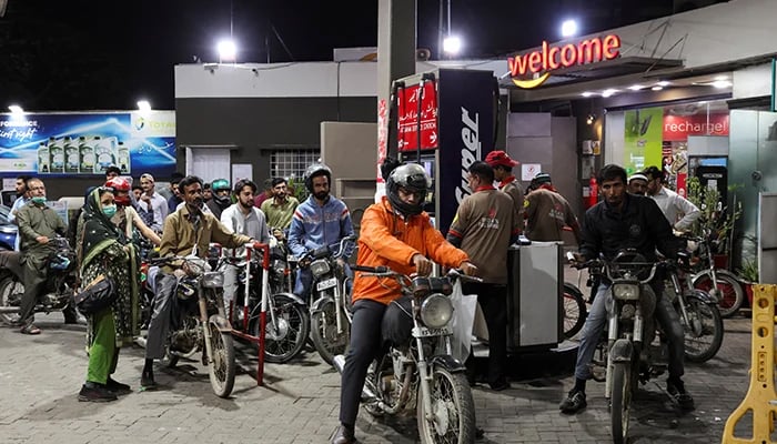 People wait for their turn to get fuel at a petrol station, amid the US and Israeli conflict in Iran, in Karachi, March 6, 2026. — Reuters